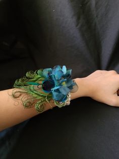 a woman's arm with a blue flower on it