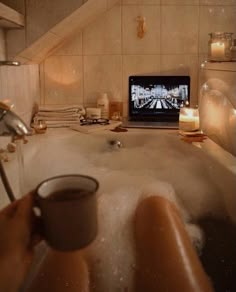 a bath room with a tv and some candles