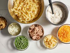 bowls filled with different types of food on top of a white counter next to each other