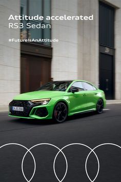 the green car is driving down the street in front of some white circles and buildings