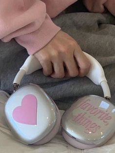 a person is sitting on a bed with headphones in their hands and the words happy valentine's day written on them