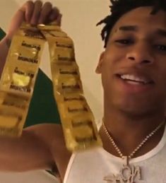 a young man holding up two packages of condoms