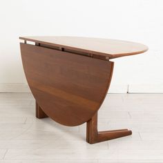 a wooden table sitting on top of a white tiled floor