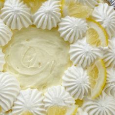 a cake with white frosting and lemons on it