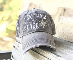 Need to change this cap design to a messy bun/high ponytail cap style, a non-distressed baseball cap or kid's baseball cap? Once you have this cap in your cart, head here: https://etsy.me/2S82fka Distinct Headwear Presents... ❄️Women's Ski Hair Don't Care Baseball Cap ❄️Main Photo shows: Dark grey cap with white text and silver snowflake. ❄️Order as shown or customize your cap and thread colors. ❄️Text will be white on all caps unless otherwise requested at checkout. ⭐CAP FEATURES: -Low profile Bun High, Goldendoodle Mom, Chicken Hats, Pink Paw Print, American Foxhound, Dinosaur Hat, Ponytail Cap, Kids Baseball Caps, Mom Hat