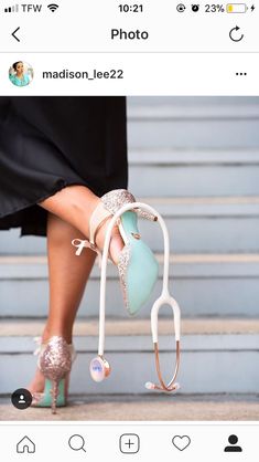 a woman's feet wearing high heeled shoes with heels attached to the toes