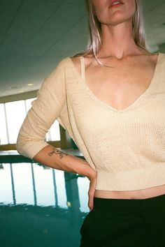 Cozy summer knit bra top with large hook closure. Cream fabric is 100% linen. Ella is 6' tall, 35" bust, 26" waist, 36" hip, and is wearing a size S. Low-cut Tops With Built-in Bra For Loungewear, Stretch Low-cut Crop Top For Summer, Summer Stretch Low-cut Crop Top, Knit V-neck Crop Top For Day Out, Seamless V-neck Crop Top For Day Out, Chic Low-cut Summer Crop Top, Chic Low-cut Summer Top, Chic Pointelle Knit Crop Top, Summer Pointelle Knit Top For Loungewear