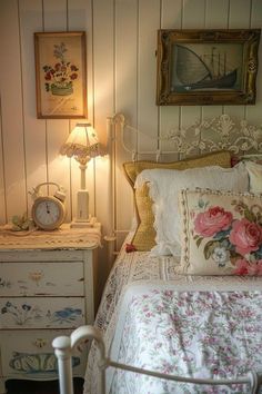 a white bed sitting next to a night stand with a clock on top of it