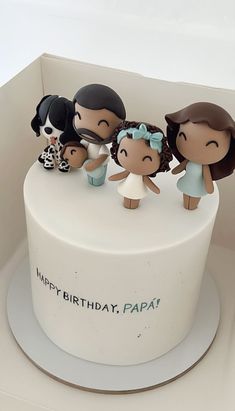 a birthday cake decorated with figurines of people