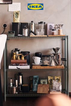 a shelf filled with lots of different types of coffee items on top of metal shelves