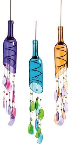 three wine bottle wind chimes hanging from the ceiling with beads and glass bottles attached to them