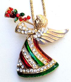 Red Green Angel Pendant / Brooch Pin on a 25" Gold Tone Necklace #2 Pendant can also be worn as a brooch/pin.  (necklace chain is included) new without tags, no defects.  See photos for details. chain = 25" pendant is approximately 2.25" wide x 2.5" high nonsmoking household. will combine shipping. Costume Jewelry Brooch For Gift, Holiday Red Brooch Jewelry, Christmas Brooch Jewelry Gift, Multicolor Brooch Jewelry For Gift, Multicolor Jewelry Brooch As Gift, Multicolor Brooch Jewelry As Gift, Christmas Gift Brooch Jewelry, Red Holiday Brooch, Christmas Gift Jewelry Brooch