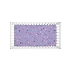 a baby crib with purple and blue designs on it