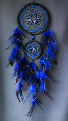 a blue dream catcher hanging on the wall