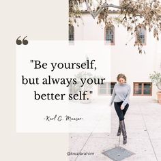 a woman standing in front of a building with a quote on it that says be yourself, but always your better self