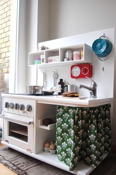 a kitchen area with an oven, microwave and other items on the counter in front of a window