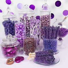 there are many different types of candies in glass jars