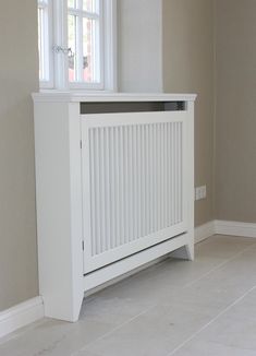 a white radiator sitting in the corner of a room