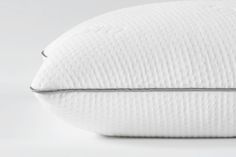 a white pillow sitting on top of a table