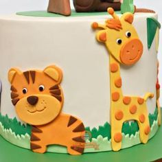 a close up of a cake with animals on it