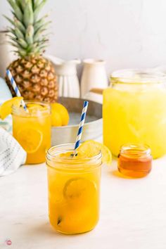 two mason jars filled with lemonade on a table