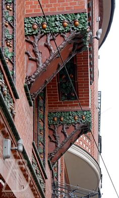 an old building with ornate iron work on the side