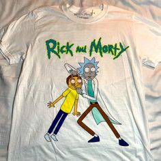 Rick And Morty T-Shirt New/W Tag White Casual T-shirt With Cartoon Print, Casual White T-shirt With Cartoon Print, White Short Sleeve T-shirt With Cartoon Print, White Pop Culture Shirt For Summer, Funny White Cotton Shirt, Pop Culture White Tops With Funny Print, White Pop Culture Shirt With Letter Print, White Crew Neck T-shirt With Cartoon Print, White Pop Culture Tops With Funny Print