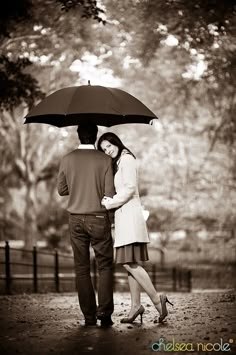 a couple standing under an umbrella in the rain