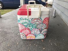 a cooler sitting on the sidewalk next to a house