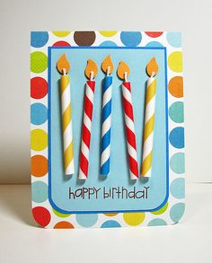 two birthday candles are on top of a card