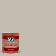 a can of behr ultra paint and primer on a gray background with the words,