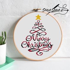 a cross stitch christmas tree with the words merry christmas