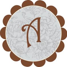 a monogrammed letter in the center of a circle with flowers and leaves around it