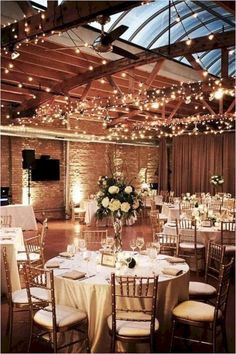 an indoor wedding venue with tables and chairs