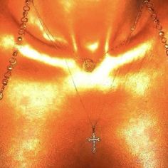 an image of a woman wearing gold with a cross on her chest and necklace around her neck