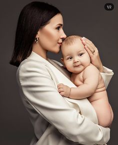 a woman holding a baby in her arms