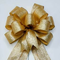 a gold bow on a white background