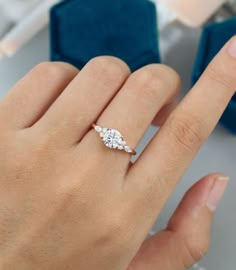 a woman's hand with a diamond ring on it and two diamonds in the middle