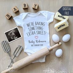 a baby's bodysuit and other items are laid out on a table