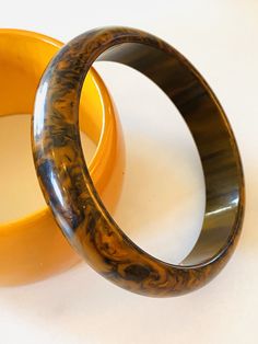 Awesome End of the Day Bakelite swirl bracelet, Mississippi Mud. If you have seen Mississippi mud you will understand... .The bracelet is in very good vintage condition, sold as found. Incredible statement set, true vintage. Standard 2.5 inch opening. 1/2 Inch wide width. Awesome swirling as shown in the photos. You will not be disappointed with this beauty, it can hold its own or show up in a Stack! .All items are shipped USPS priority mail signature required, fully insured upon completion of t Vintage Brown Bracelet Gift, Handmade Vintage Round Bracelets, Vintage Brown Bangle As A Gift, Mid-century Bangle Bracelet For Gift, Mid-century Bangle Bracelets As Gifts, Retro Brown Bracelets As Gift, Adjustable Brown Vintage Bangle, Retro Round Bracelet Gift, Retro Bracelet As Gift