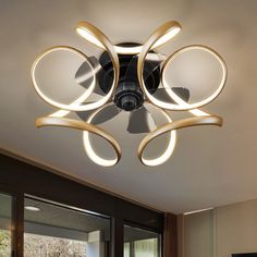 a ceiling fan with lights on it in a room