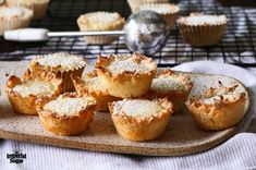 several small cupcakes on a tray next to other muffins