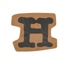 the letter h is made out of cardboard and has black paint on it's upper half