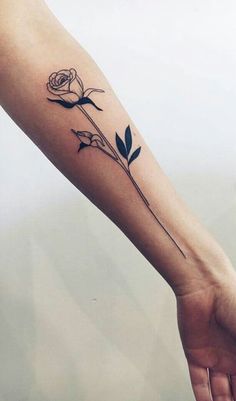 a woman's arm with a rose tattoo on it, and the outline of a flower