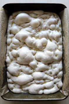 a pan filled with white bread sitting on top of a table