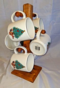 there are many cups and saucers on the wooden stand