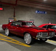 two cars parked in a parking garage next to each other