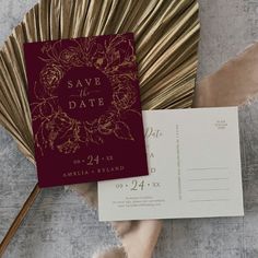 a red and gold save the date card next to a fan