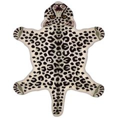 a white and black animal print rug with spots on it's back end,