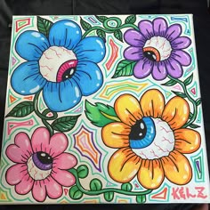 the painting is colorful and has flowers painted on it's sides, including one blue eye